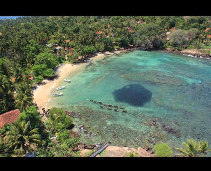 an aerial view of a beach with boats in the water at Light house beach home in Matara