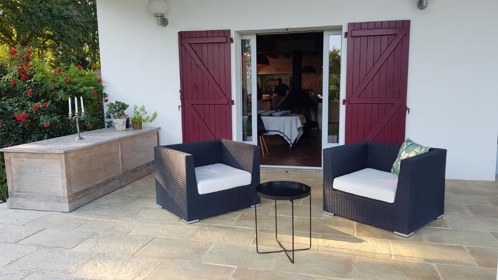 two chairs and a table on a patio at Maison d hotes Lapitxuri in Arcangues