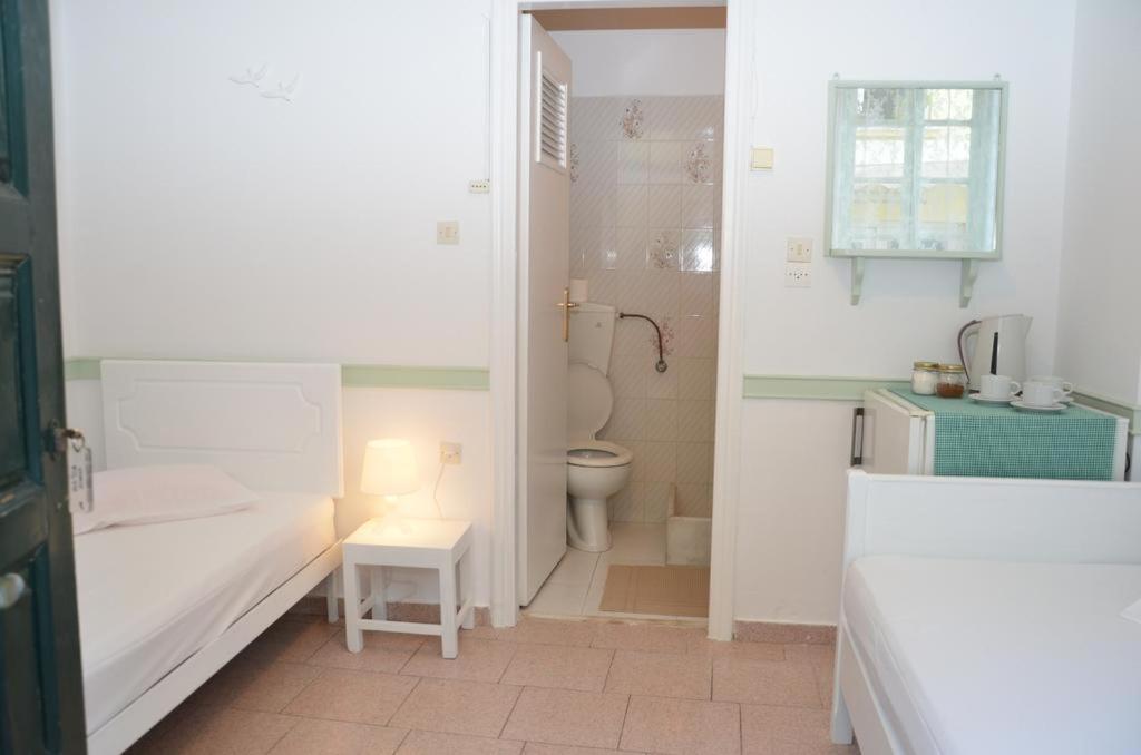 Postel nebo postele na pokoji v ubytování Aegli Rooms