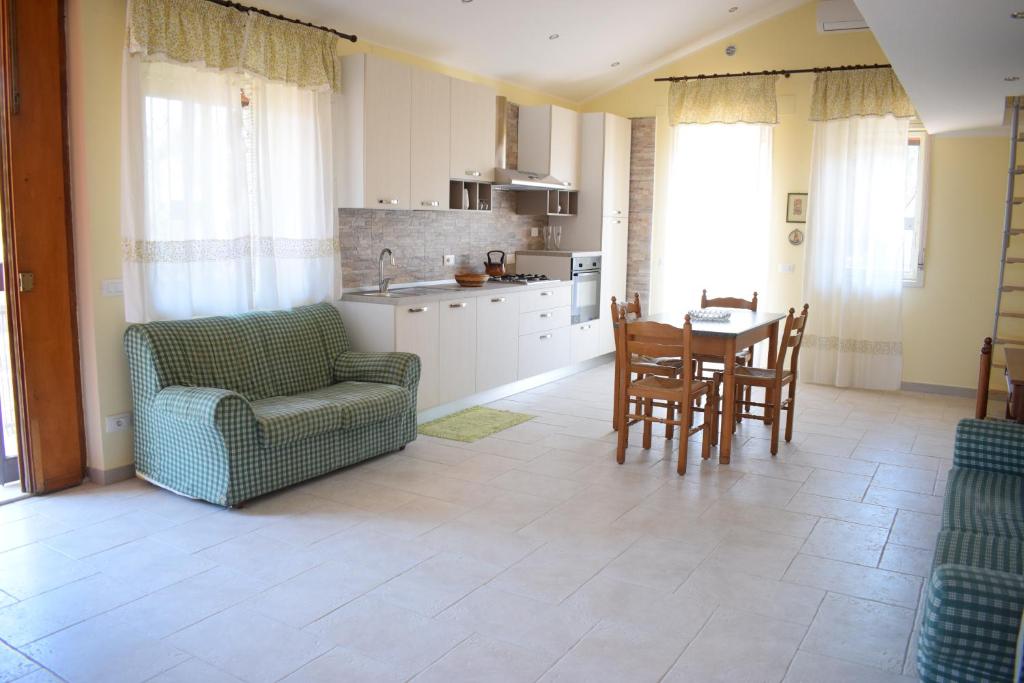 a kitchen and dining room with a table and chairs at Beach House Vaccarizzo in Catania