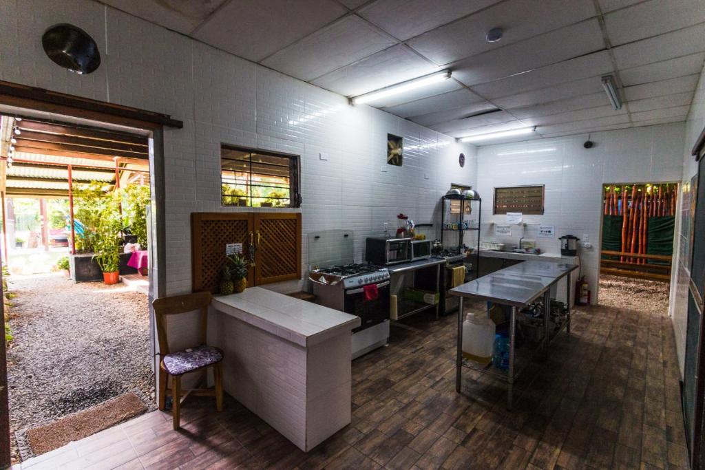 a large kitchen with a counter and a table at Bodhi Hostel & Lounge in Valle de Anton