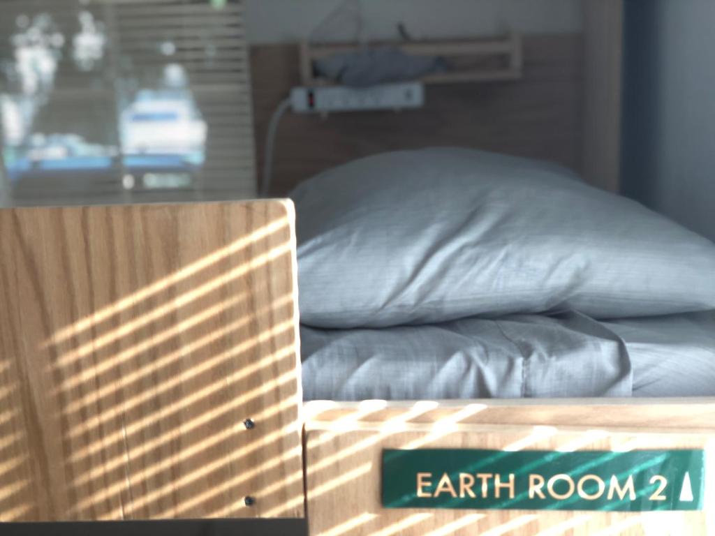 ein Bett mit Kissen und ein Schild, das Erde liest in der Unterkunft WHOLE Family - WholeVille in Sacramento