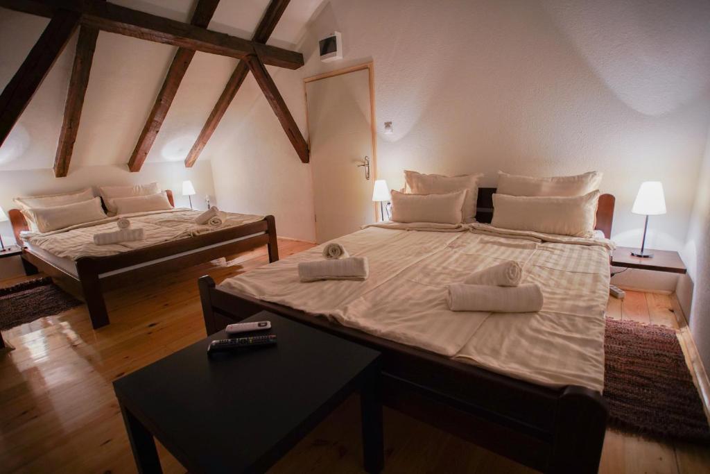 a bedroom with two beds and a table in it at Epicenter in Niš