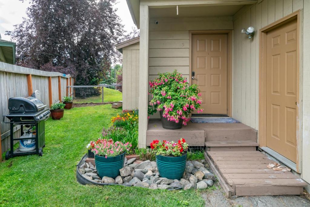 a house with three potted plants on the front door at Polar Bear Den in Anchorage