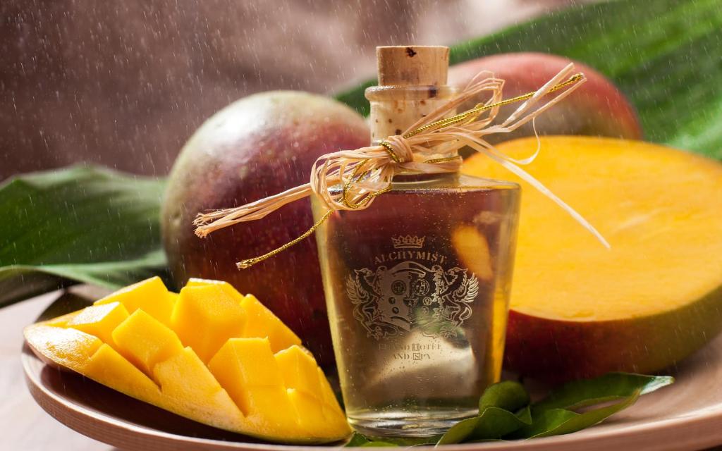 a bottle of oil next to a plate of fruit at Alchymist Grand Hotel and Spa - Preferred Hotels & Resorts in Prague