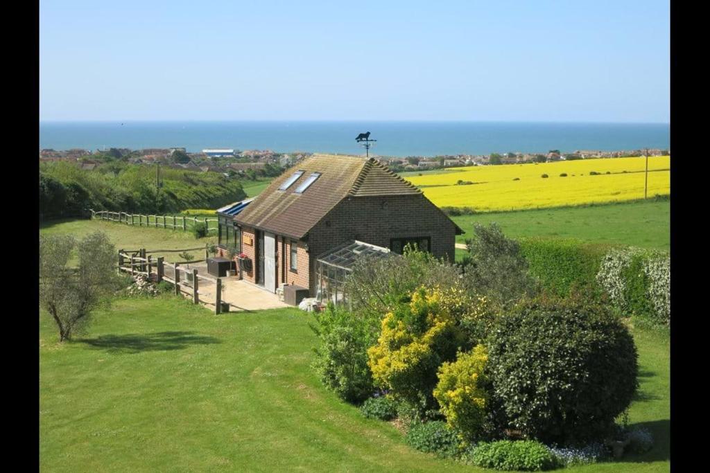 a small house in the middle of a field at The Old Stable. Coombelands in Brighton & Hove