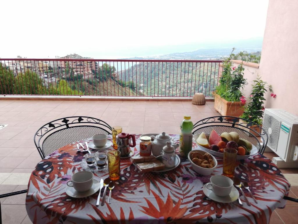 a table with a bowl of fruit on a balcony at Casa Romeo in Taormina