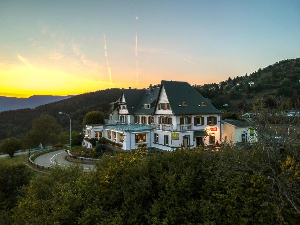 a large house sitting on top of a hill at Hôtel Panorama in Munster