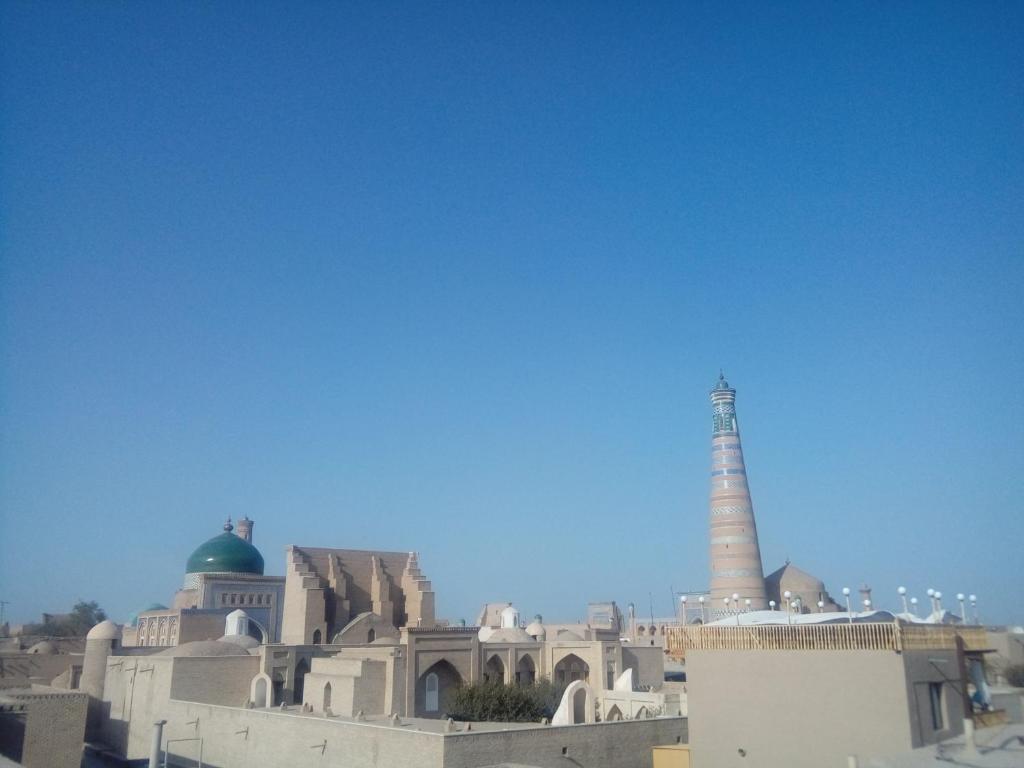a view of a city with a mosque and a lighthouse at Fayz Guest House in Khiva