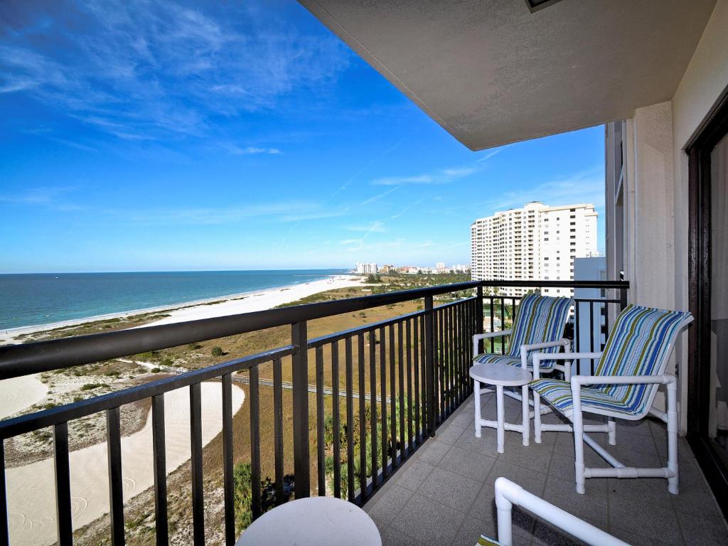 two chairs on a balcony with a view of the beach at Harbour Light Towers 1105 11th Floor Beachfront Studio at Harbour Light Towers 23118 in Clearwater Beach