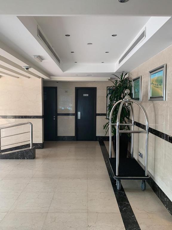 a hospital hallway with a waiting room with a plant at Paragon Hotel Apartments in Abu Dhabi