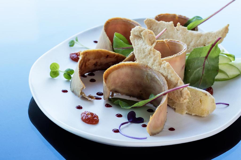 a plate of food with a sandwich and chips at Eurostars Torre Sevilla in Seville