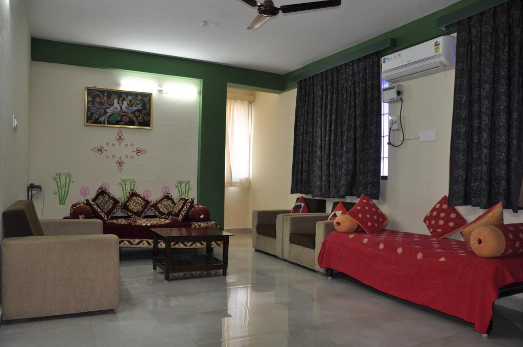 a living room with two couches and a couch at Nayath Serviced Apartments in Tirupati