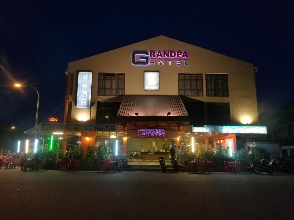 a building with a sign that reads ramara hotel at Grandpa Hotel in Port Dickson