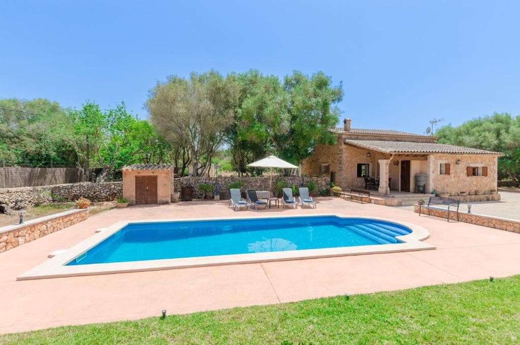 a swimming pool in a yard with a house at Son Garbi in Algaida