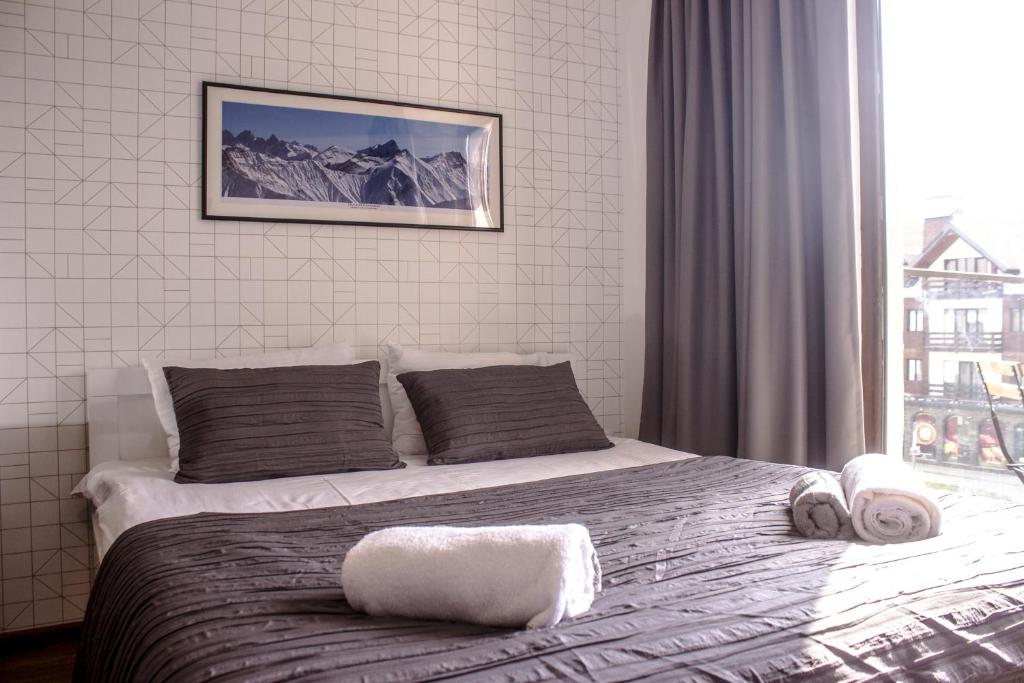 a bedroom with a large bed with a window at New Gudauri Loft 1 Apartment in Gudauri