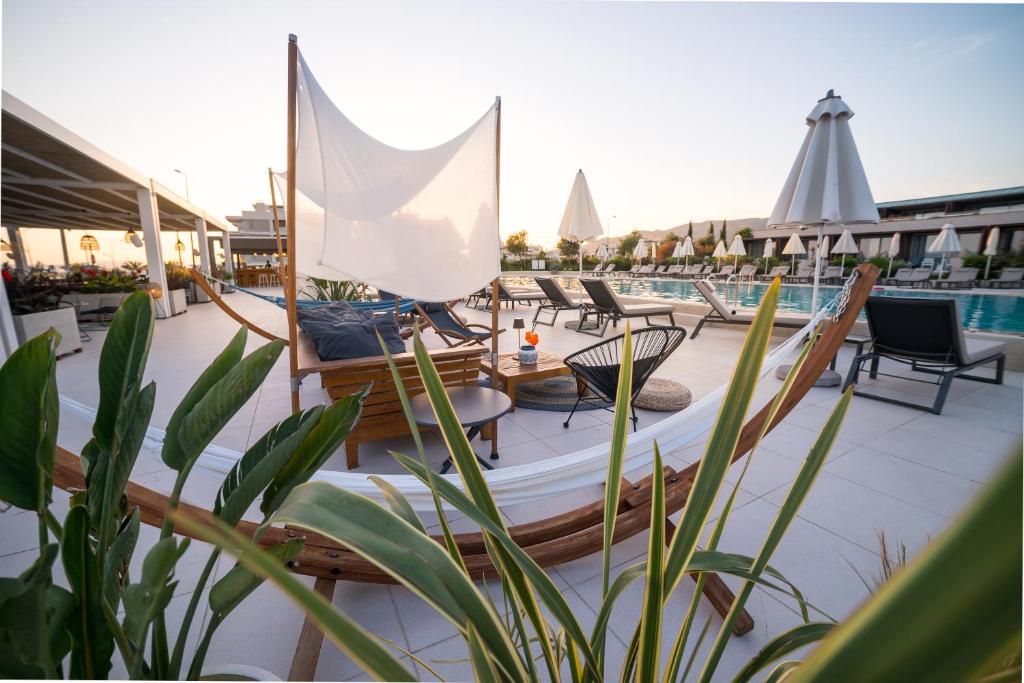a boat with a sail on a deck with chairs at Horizon Blu Boutique Hotel in Kalamata
