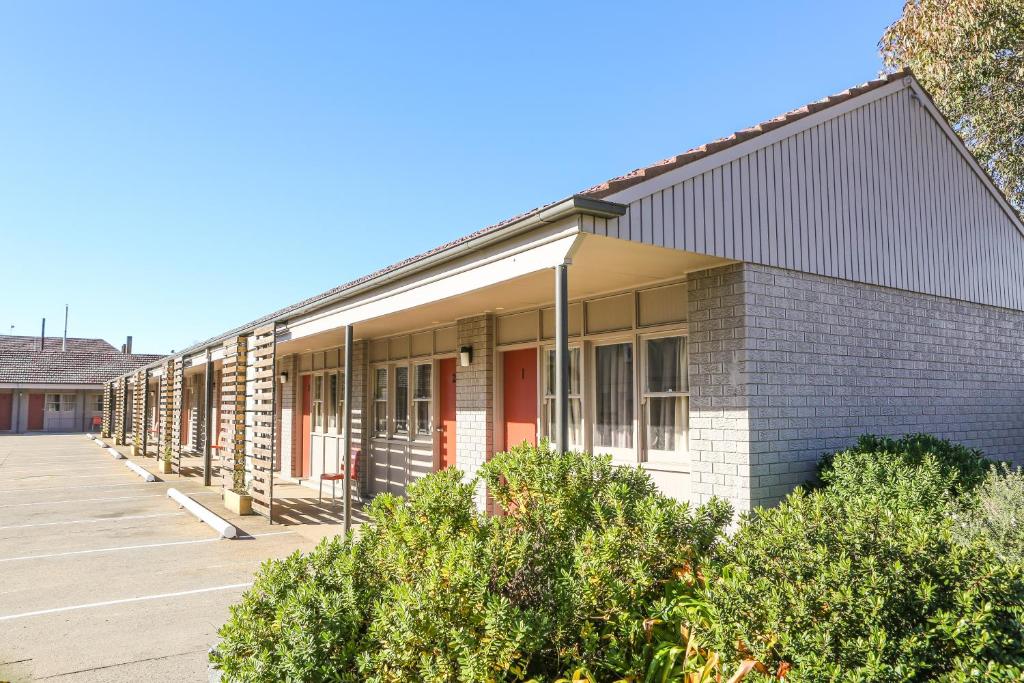 a row of buildings with trees in front of them at Kite Street Units in Orange