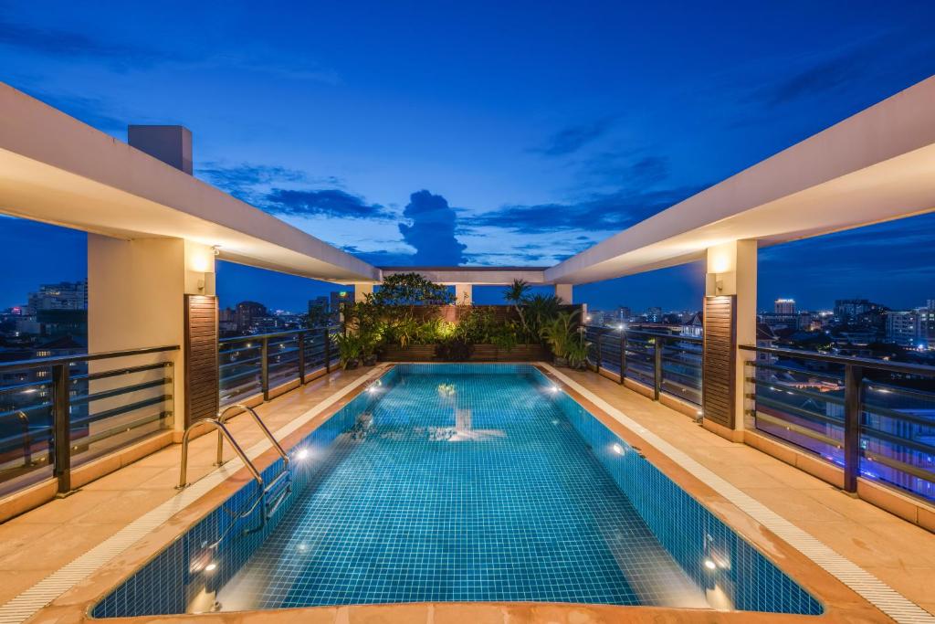 a swimming pool on the balcony of a building at night at City View Apartment in Phnom Penh