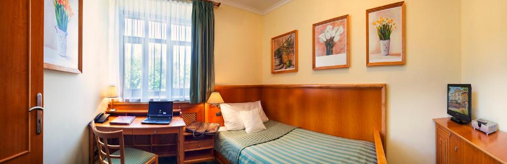 Postel nebo postele na pokoji v ubytování Hotel Abácie & Wellness