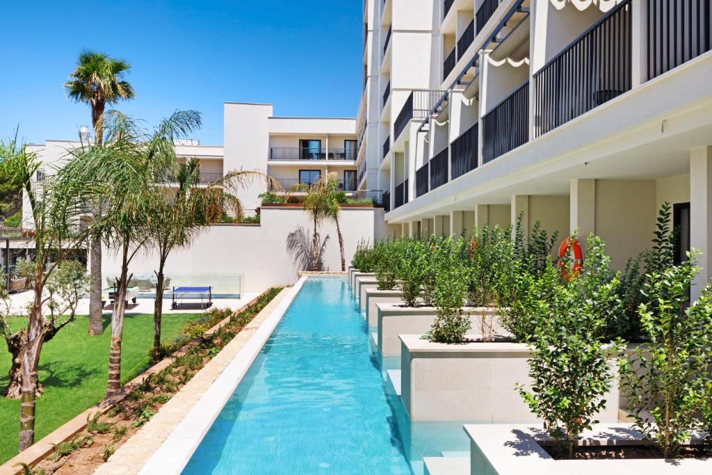 an external view of a building with a swimming pool at Hotel Paradiso Garden in Playa de Palma