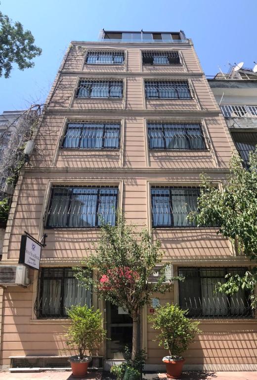 a tall building with windows and plants in front of it at Style Star Hotel Cihangir in Istanbul