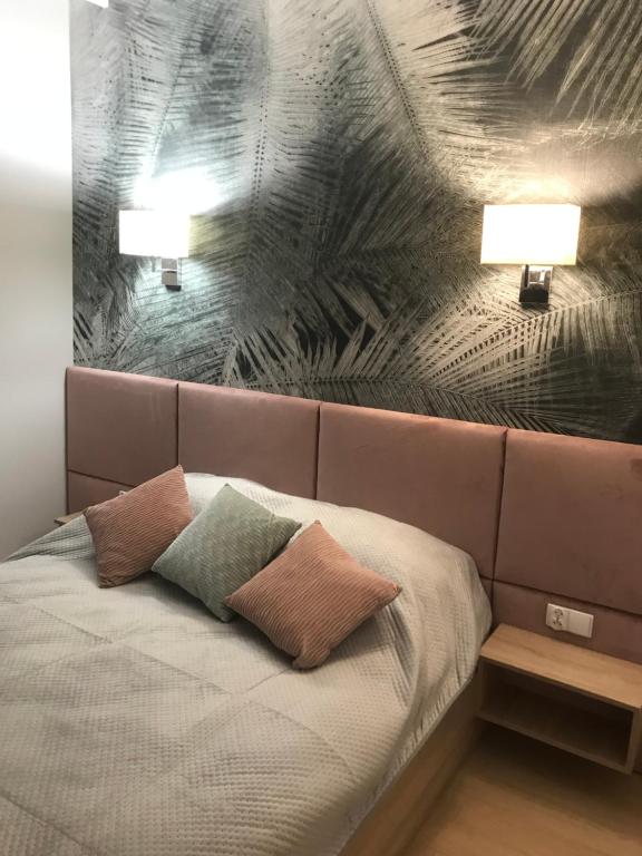 een slaapkamer met een bed met 2 kussens en 2 lampen bij Apartament the Good Place in Brodnica