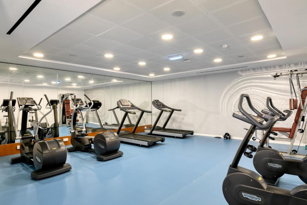 a gym with treadmills and elliptical machines at Ivi Mare - Designed for Adults by Louis Hotels in Paphos