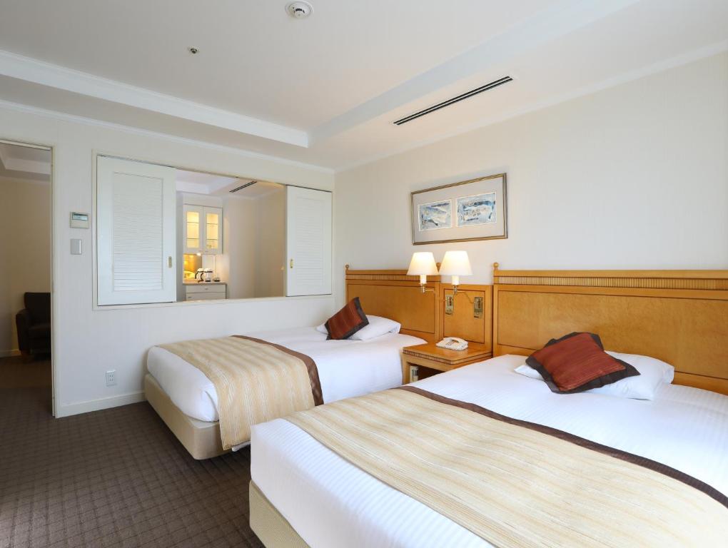 Postel nebo postele na pokoji v ubytování Wishton Hotel Yukari