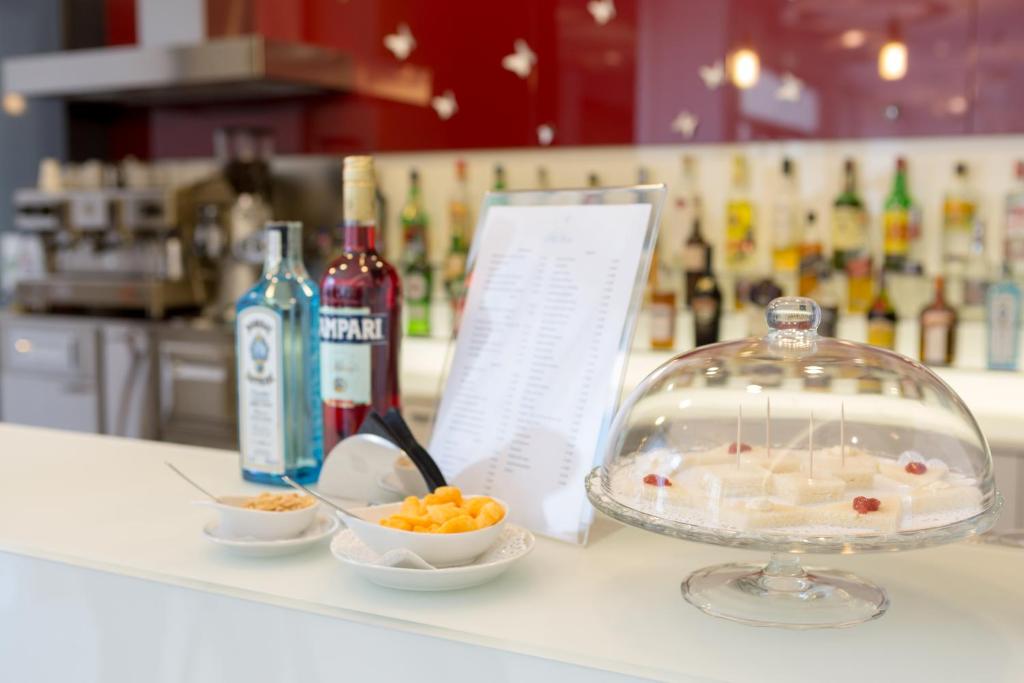 a counter with a bowl of food and a bowl of fruit at Hotel Cristina in Naples