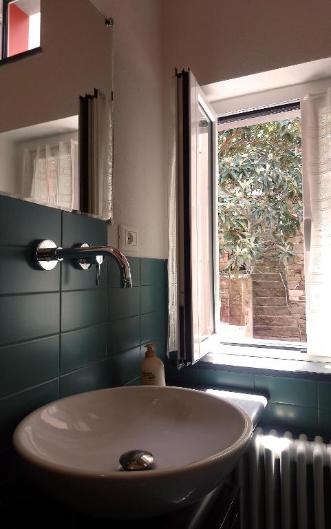 a bathroom with a sink and a window at Arbanella in Corniglia