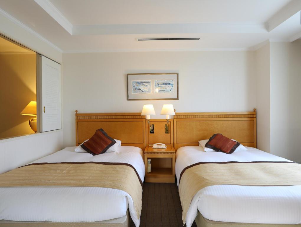 Postel nebo postele na pokoji v ubytování Wishton Hotel Yukari