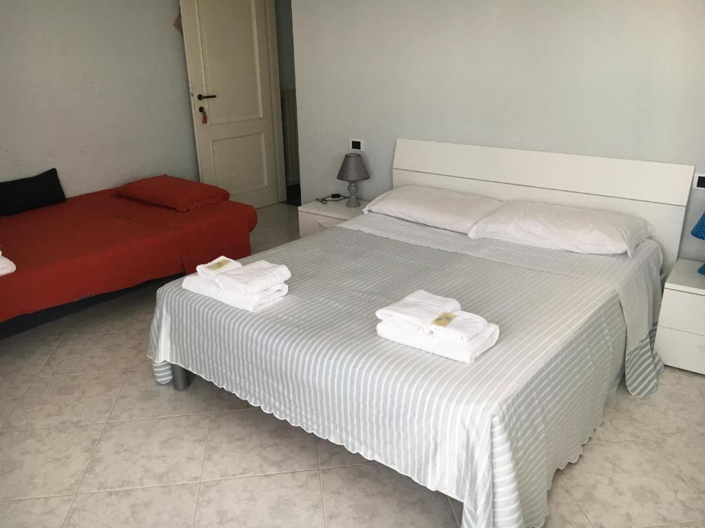 Postel nebo postele na pokoji v ubytování Hotel Gianna