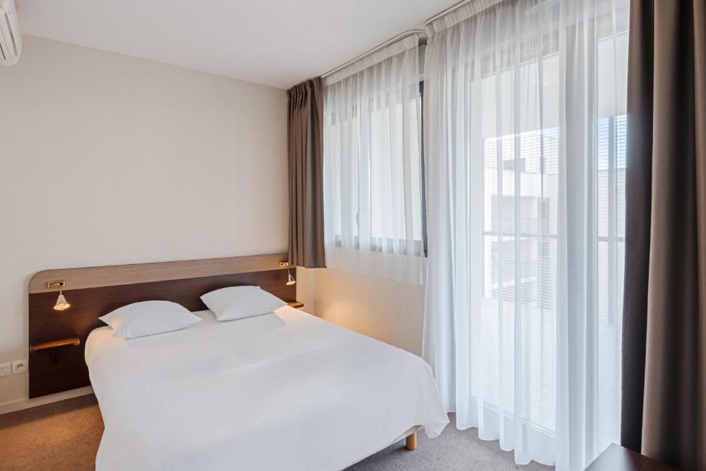 Ένα ή περισσότερα κρεβάτια σε δωμάτιο στο Appart'City Classic Montelimar