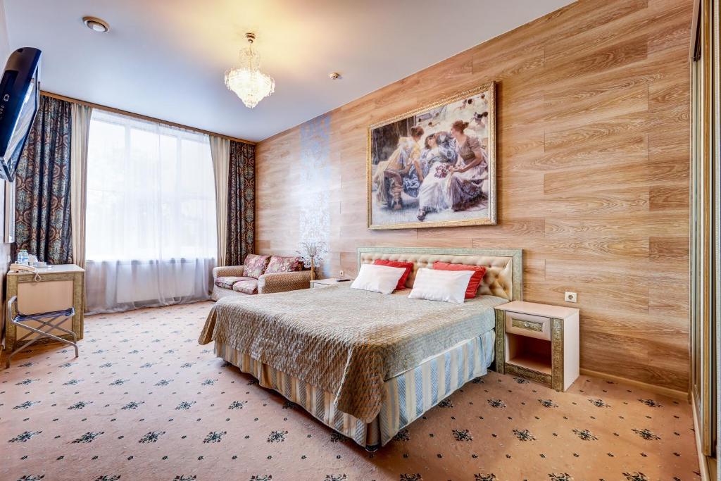 a bedroom with a bed and a painting on the wall at Sunflower River Hotel Moscow in Moscow