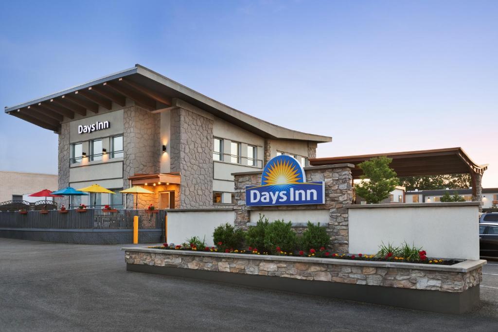 a building with a day inn sign in front of it at Days Inn by Wyndham Montreal East in Montreal