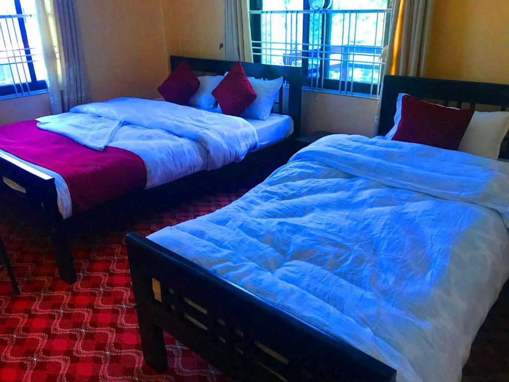 Postel nebo postele na pokoji v ubytování Hotel Brisha Sarangkot