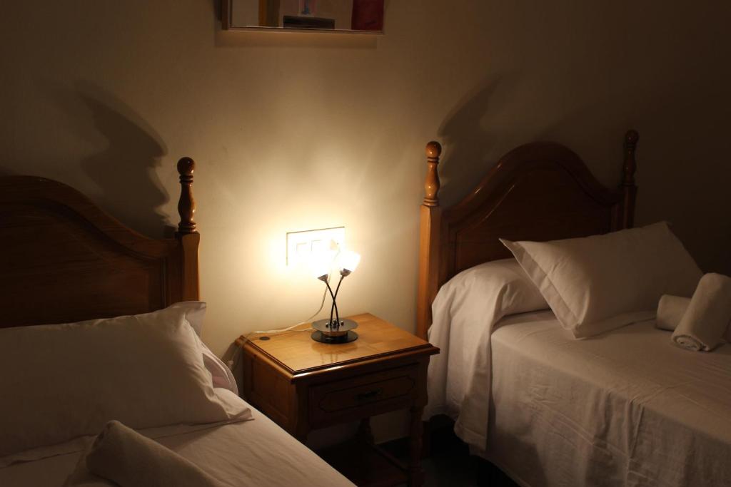 Postel nebo postele na pokoji v ubytování Hostal Los Maños