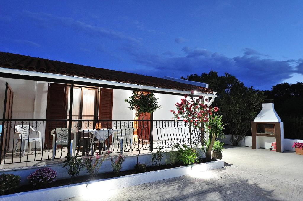 a balcony of a house with flowers on it at Anastazia Paradise in Kolios