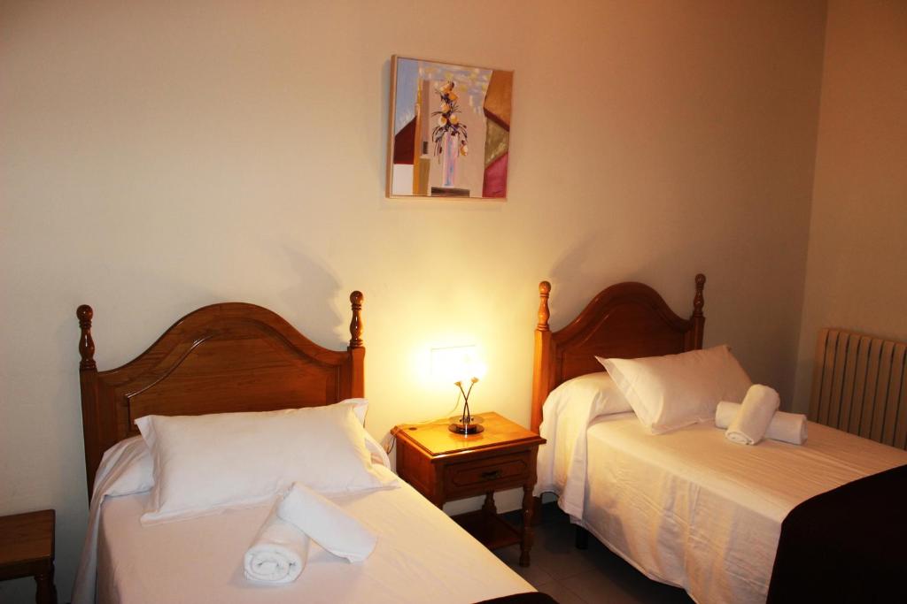 Postel nebo postele na pokoji v ubytování Hostal Los Maños