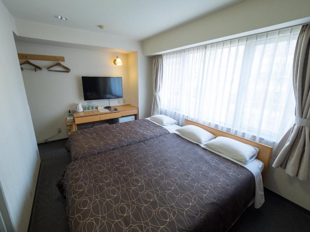 Postel nebo postele na pokoji v ubytování Hotel Shin Osaka
