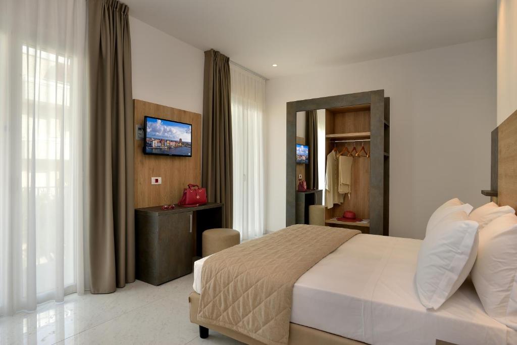 Postel nebo postele na pokoji v ubytování Hotel Ducale