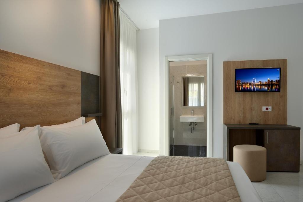 Postel nebo postele na pokoji v ubytování Hotel Ducale