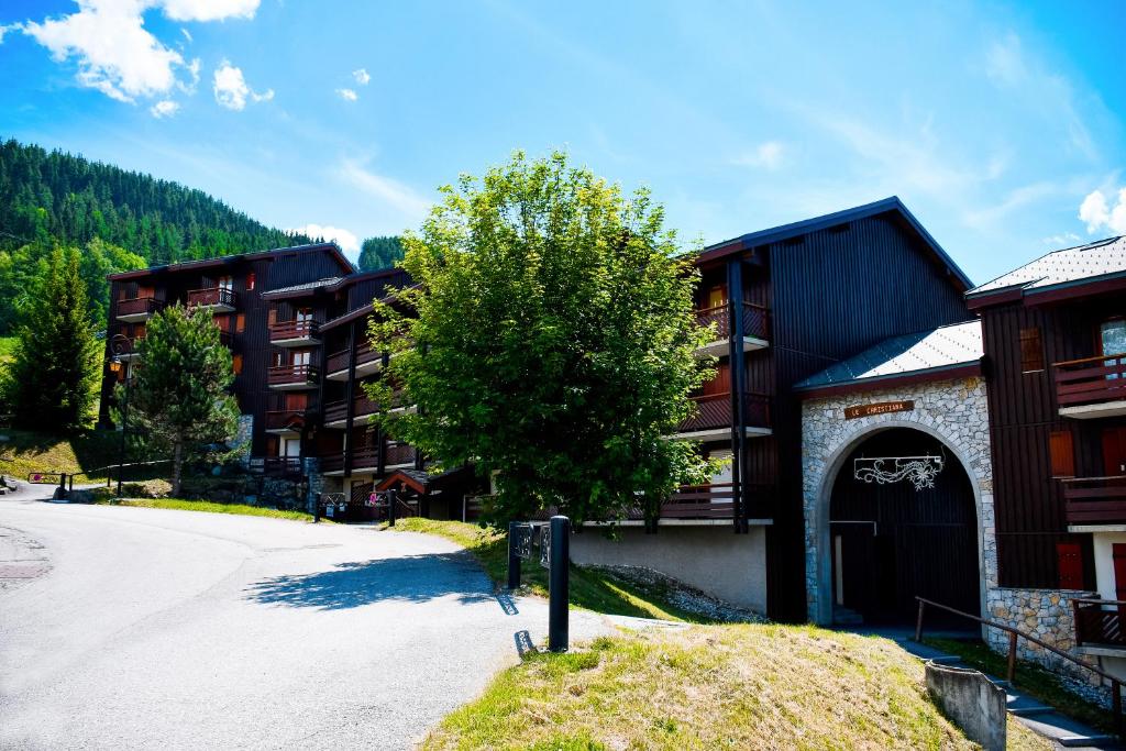 a parking lot in front of a building at Your apartment near the ski lift in Aime La Plagne