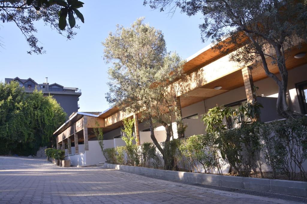 a building with a sidewalk in front of it at Heybeli Garden in Bursa