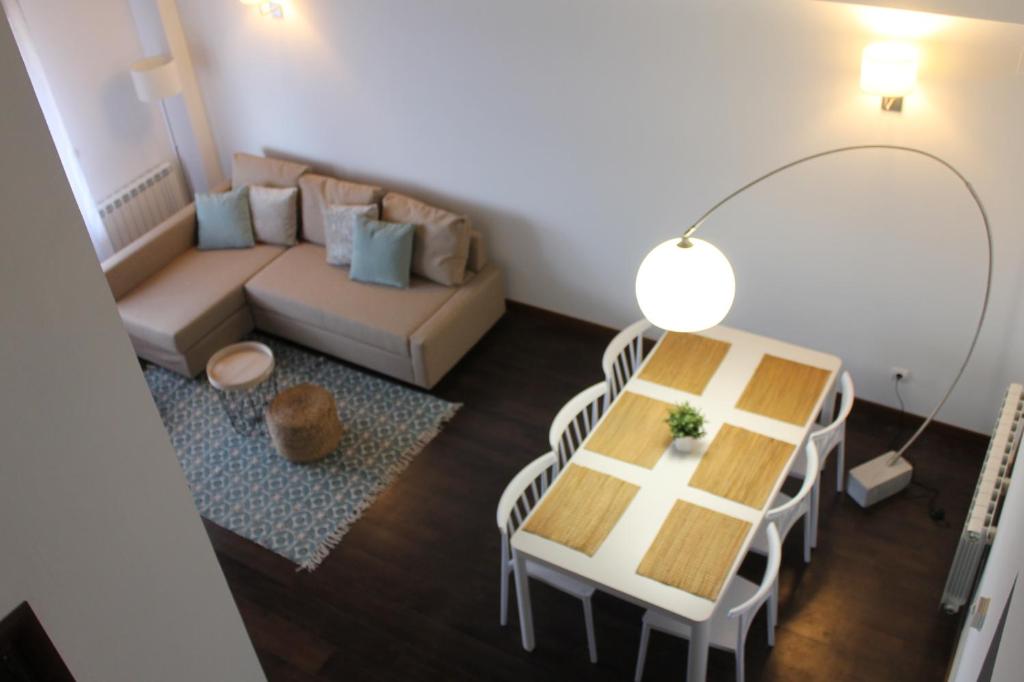 ein Wohnzimmer mit einem Tisch und einem Sofa in der Unterkunft Duplex en Campo de Golf in Sojuela