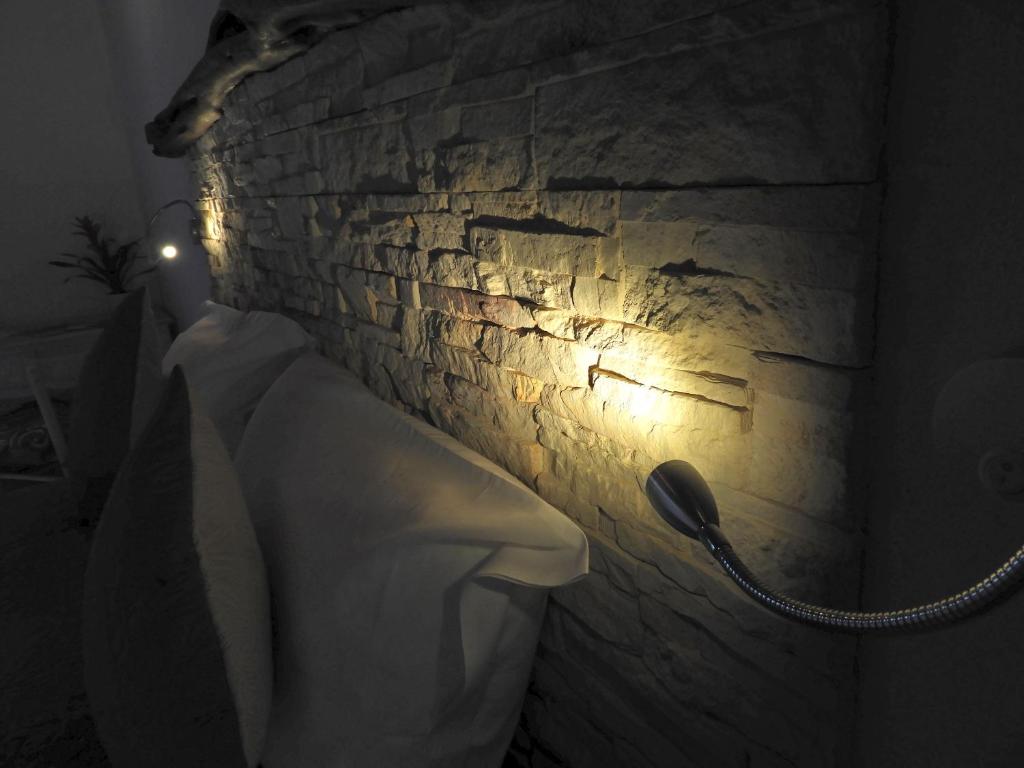 a stone wall with a phone in a bathroom at Acquamaris Tuerredda in Teulada