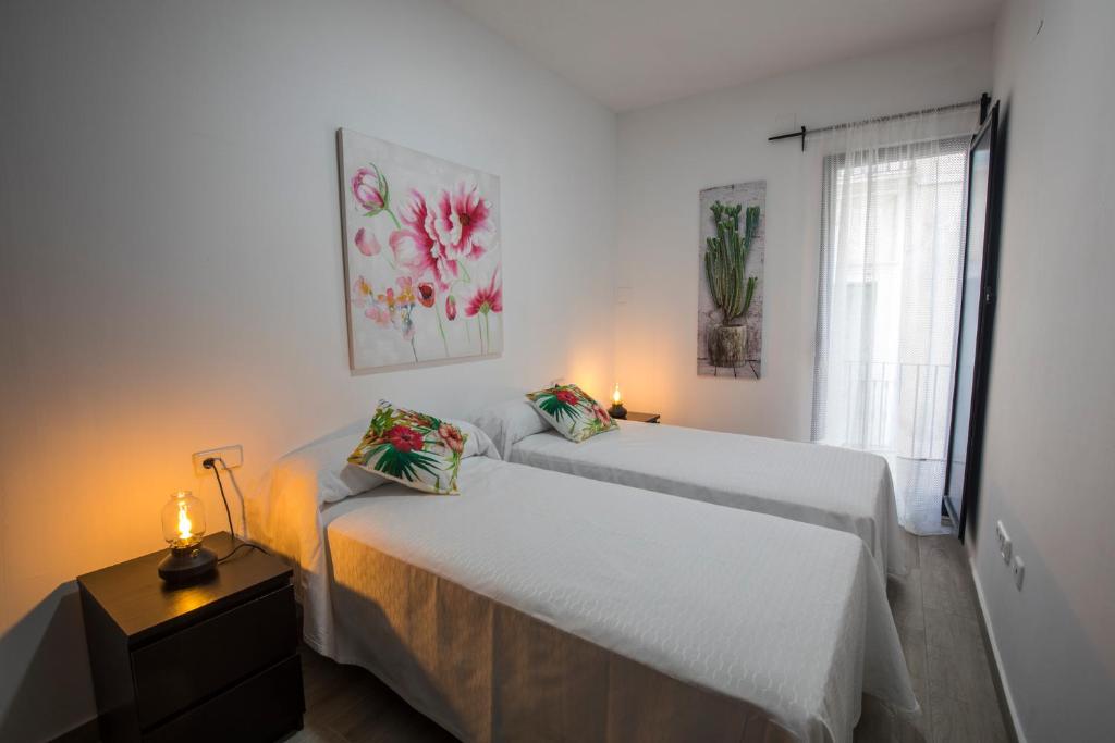 Postel nebo postele na pokoji v ubytování Apartamentos Cáceres Turístico