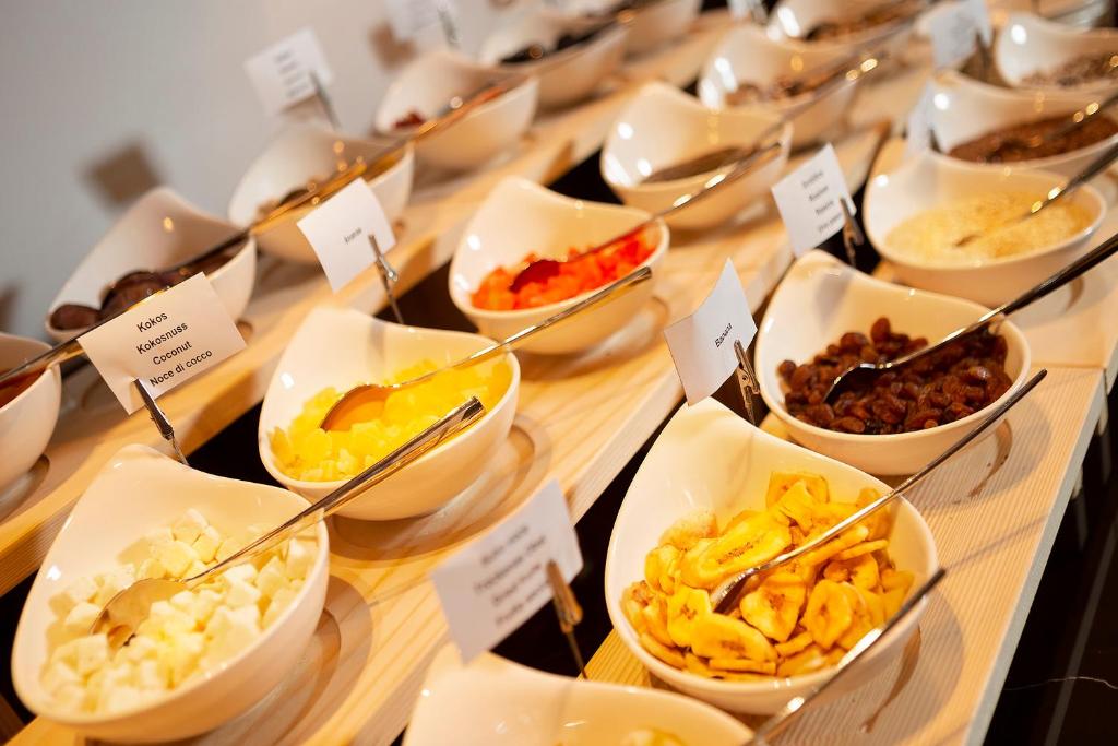 a buffet with bowls of different types of food at Luxury Hotel Riva in Malinska