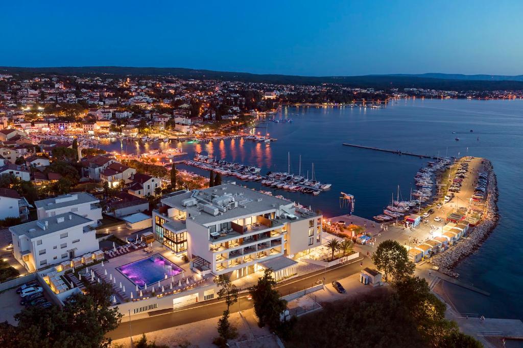 una vista aerea di un porto turistico di notte di Luxury Hotel Riva a Malinska